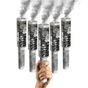 Fumigène à main blanc en pleine activation, dégageant une fumée dense et homogène dans un espace extérieur.